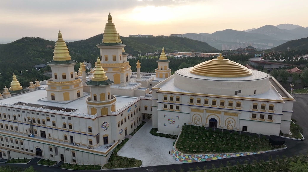 Chishan Fahua Temple complex with golden pagodas and domes in Weihai Shandong at sunset