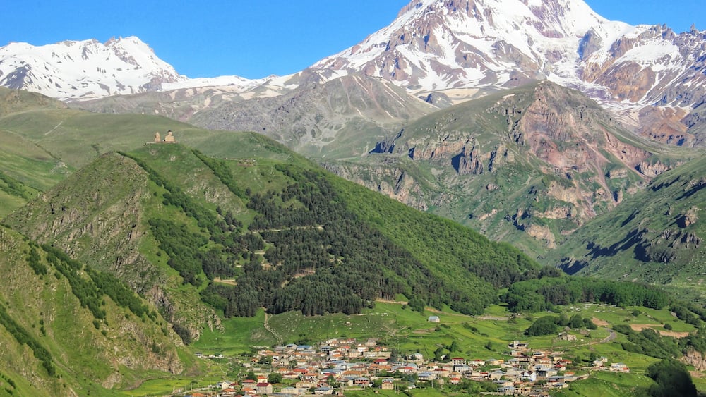 The majestic Mount Kazbek, standing at 5033 metres above sea level.
When we arrived into Kazbegi the mountain was all in shade and there was a lot of cloud around.
However when we awoke the next morning, this was our view from the balcony of our room at Rooms Hotel Kazbegi.
To read more about the places I visited on my 10-day Georgia itinerary by public transport, click on the following link.
https://galloparoundtheglobe.com/a-10-day-georgia-itinerary-by-public-transport/