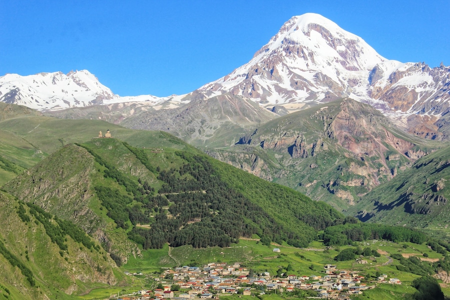 The majestic Mount Kazbek, standing at 5033 metres above sea level.
When we arrived into Kazbegi the mountain was all in shade and there was a lot of cloud around.
However when we awoke the next morning, this was our view from the balcony of our room at Rooms Hotel Kazbegi.
To read more about the places I visited on my 10-day Georgia itinerary by public transport, click on the following link.
https://galloparoundtheglobe.com/a-10-day-georgia-itinerary-by-public-transport/