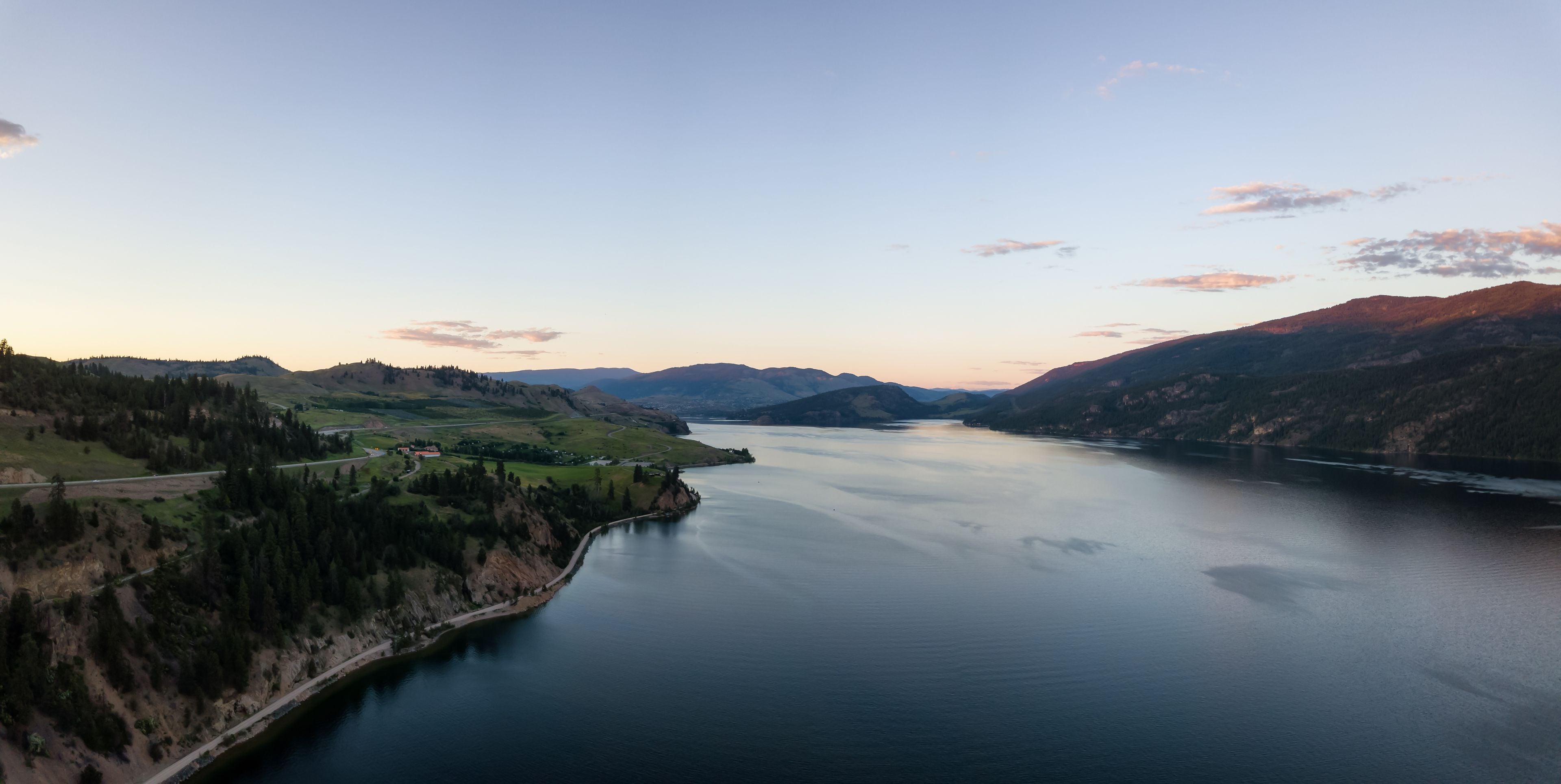 Aerial panoramic view of Kalamalka Lake during a vibrant summer sunset. Located near Kelowna and Vernon, BC, Canada.