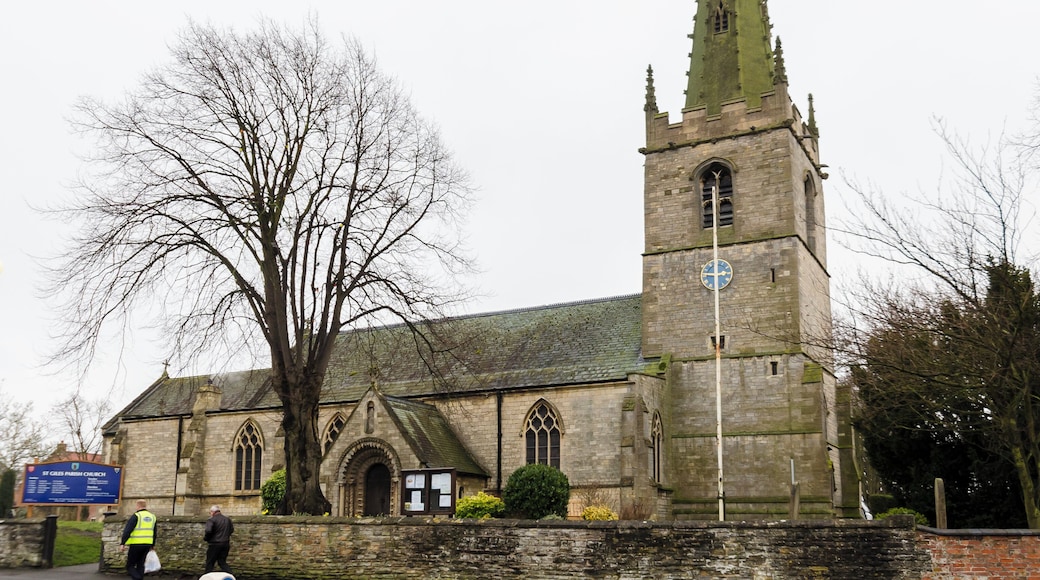 Balderton dates back to Saxon times, and it is known that Lady Godiver the wife of Earl Leofric had property nearby. In the past the Great North Road from London to York passed through the village. There is no trace of an original Saxon church, although one probably existed. The church dates from the 12th century when a simple building, some of which still remains in the nave, was constructed. The north and south doorways still retain Norman arches with zigzag patterning (although both have been moved from their original position). The church consists of a tower with spire, nave with north and south aisles, north and south porches, and a chancel with north Chapel which houses the organ. The tower dates from the 13th century and is of three stages. It was encased in ashlar in the 1880s. The top is embattled with pinnacles and gargoyles. The spire dates from circa 1400 and is crocketted with lucarnes. There are 8 bells. The nave has four bay arcades with octagonal piers. In the 13th century the north aisle was added and a larger chancel was built. Shortly after, the nave was extended westward, and the building of the tower commenced, this was delayed by the Black Death of 1347. The south aisle was added in the 14th century. The font also dates from this time. It is octagonal, with ball flower ornamentation. Around this time a clerestory was added, which was later removed in Victorian times. The screen dates from the 15th century and it was originally brightly painted and had panels of Biblical scenes. Evidence of the stonework supporting the rood loft was removed during restoration in 1882. In the late 15th century the pews were installed. These have carved poppy heads depicting animals and other figures, one man is playing Lincolnshire bagpipes. There are also undecorated 19th-century pews. The pulpit is from around 1475 and was previously on the south side of the chancel arch but was moved in 1882. The north door with its wicket is of the same 15th century period. The Victorian restoration of the church took place in 1882, when the nave roof was altered and the clerestory removed. The chancel roof had already been replaced in 1850, and additional pews were installed. The north porch was rebuilt incorporating the Norman arch. In 1929 cracks were found in the tower wall and major repairs to the foundations were undertaken. A new vestry was constructed in 1964 on the south side of the church. In 1983 the chancel was encased in Ancaster stone, matching the rest of the church. There are several 19th-century stained-glass windows and some reset fragments of 15th century glass which were found in the churchyard.