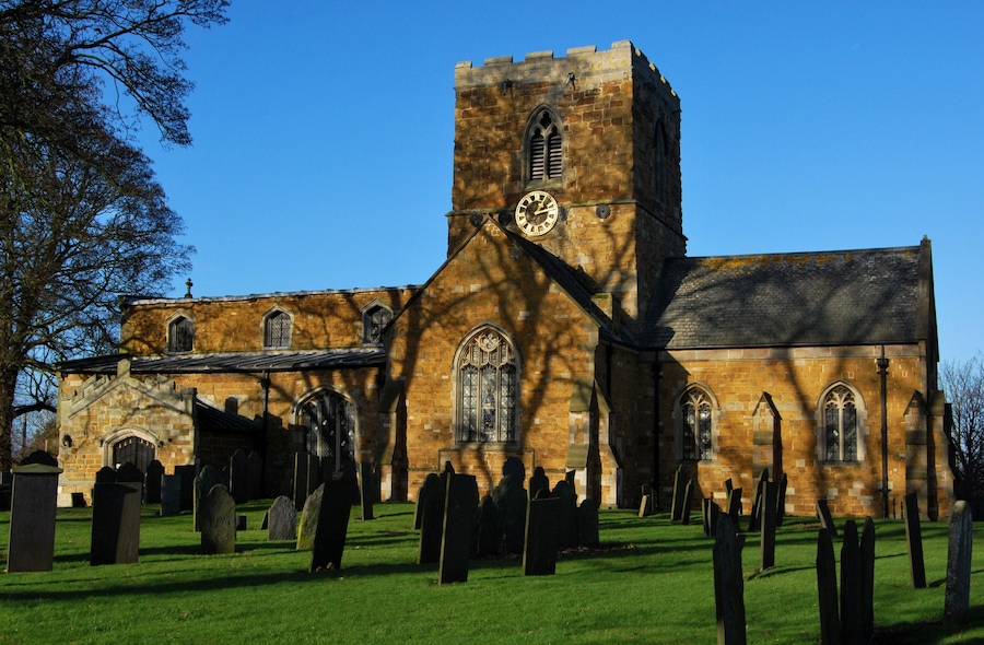 A historic church with a tall tower and stained glass windows.
