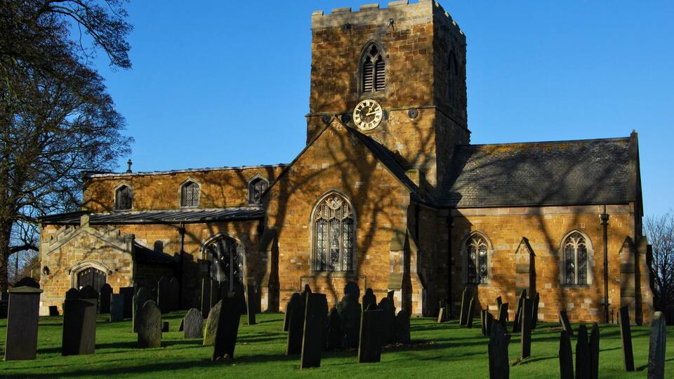 A historic church with a tall tower and stained glass windows.