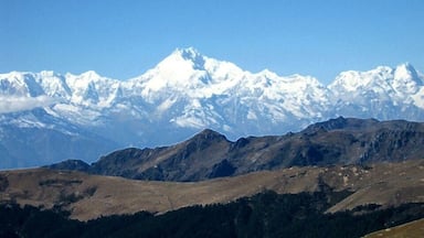 A range of snow-capped mountains under a clear blue sky.