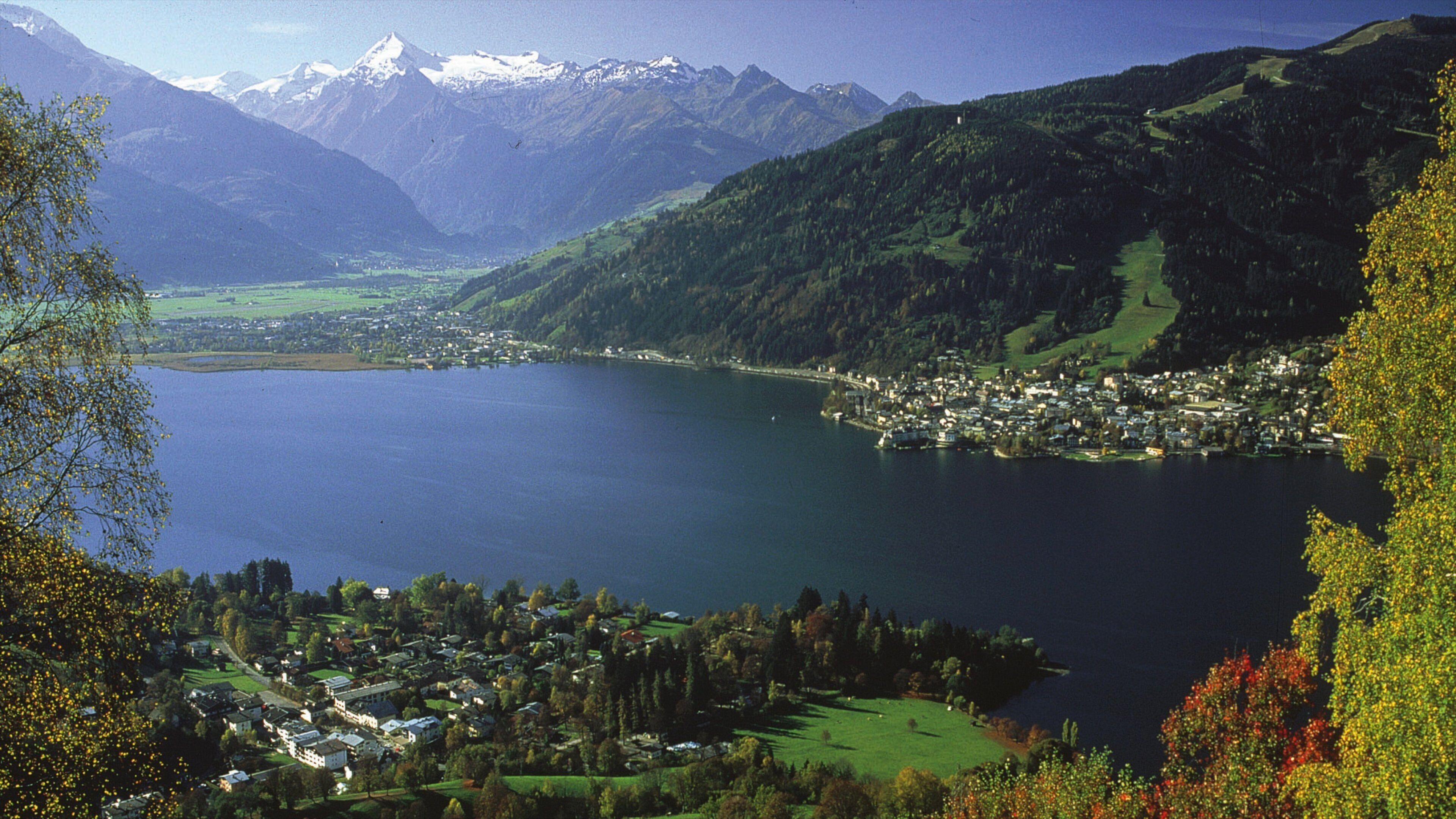 A lake surrounded by mountains and a small town.