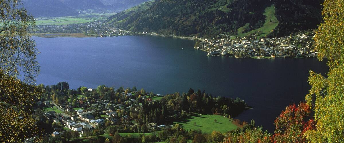 A lake surrounded by mountains and a small town.