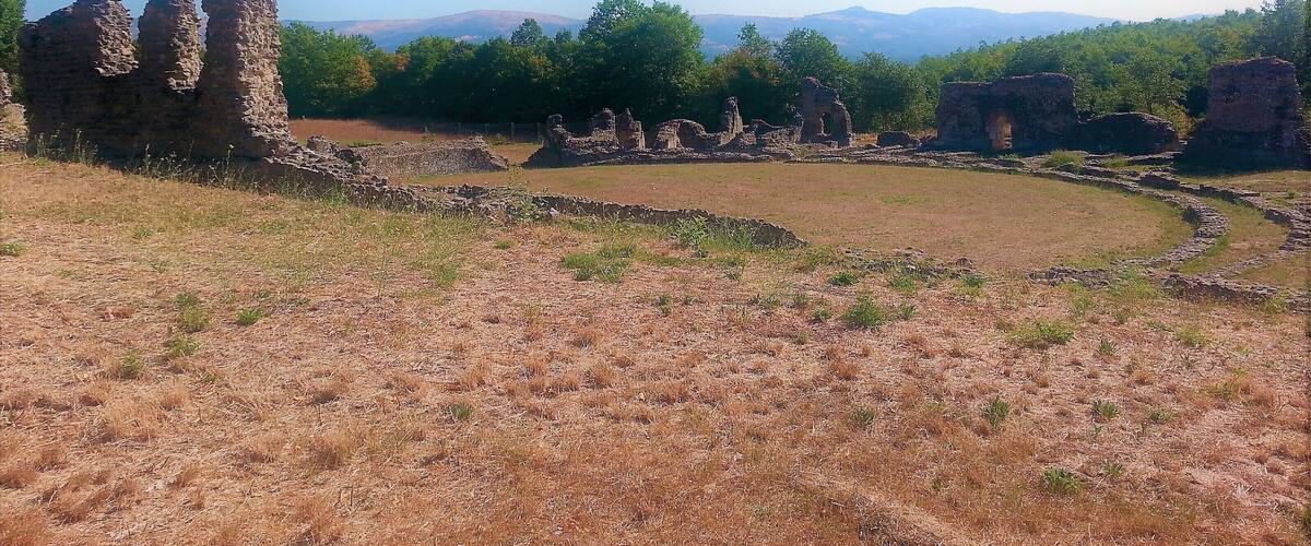 Ancient ruins with stone structures and a clear sky.