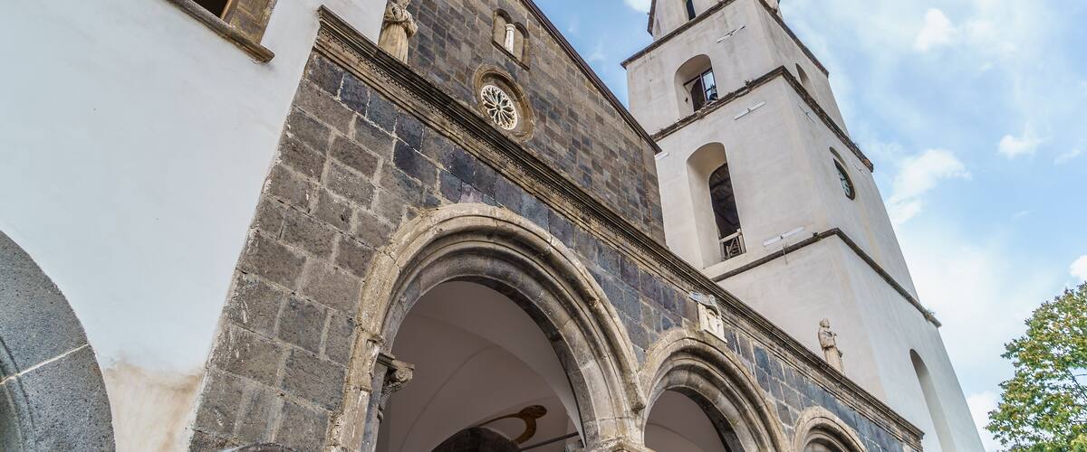 A historic church with a clock tower and arched windows.