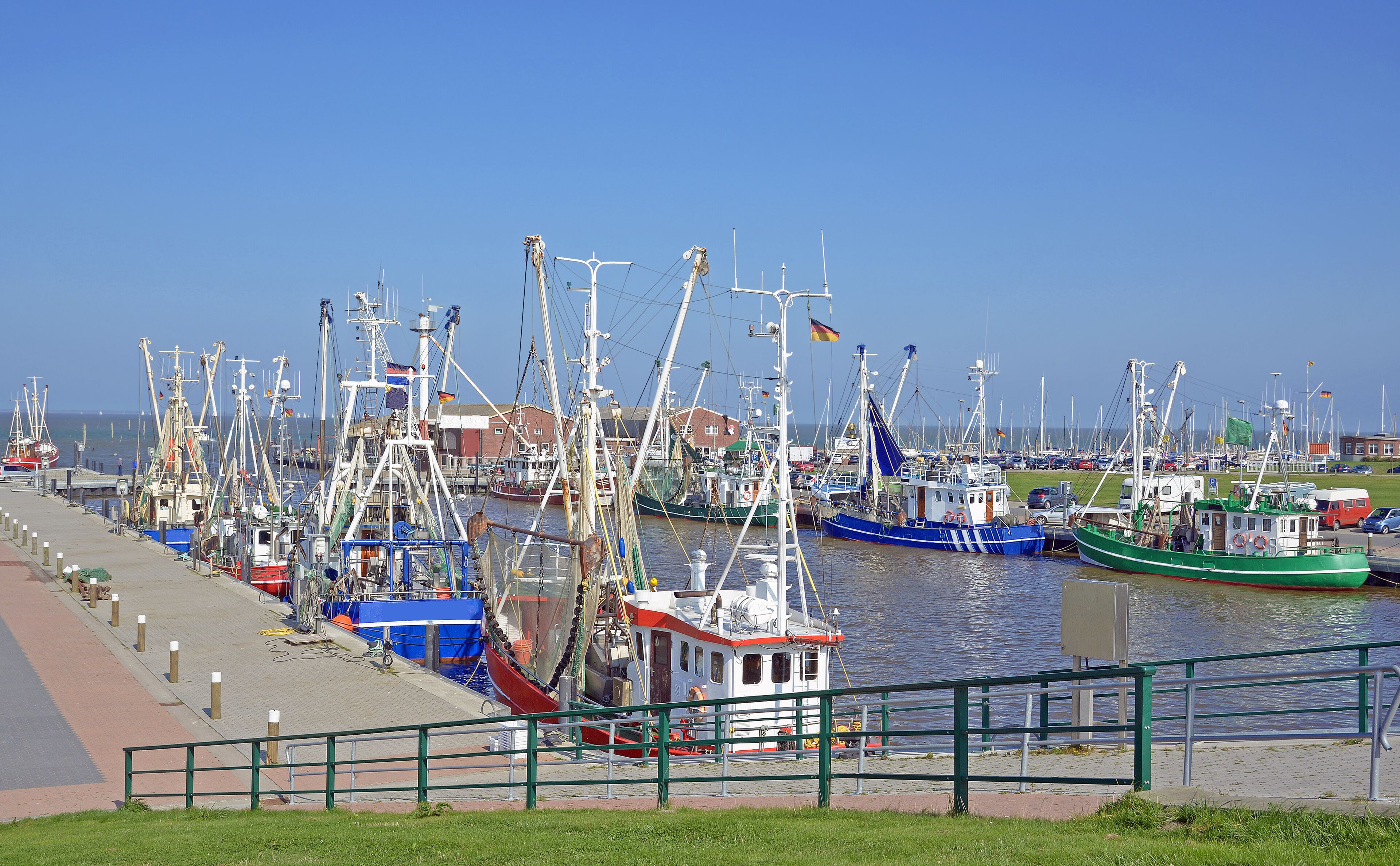 A marina with various fishing boats docked along the waterfront.