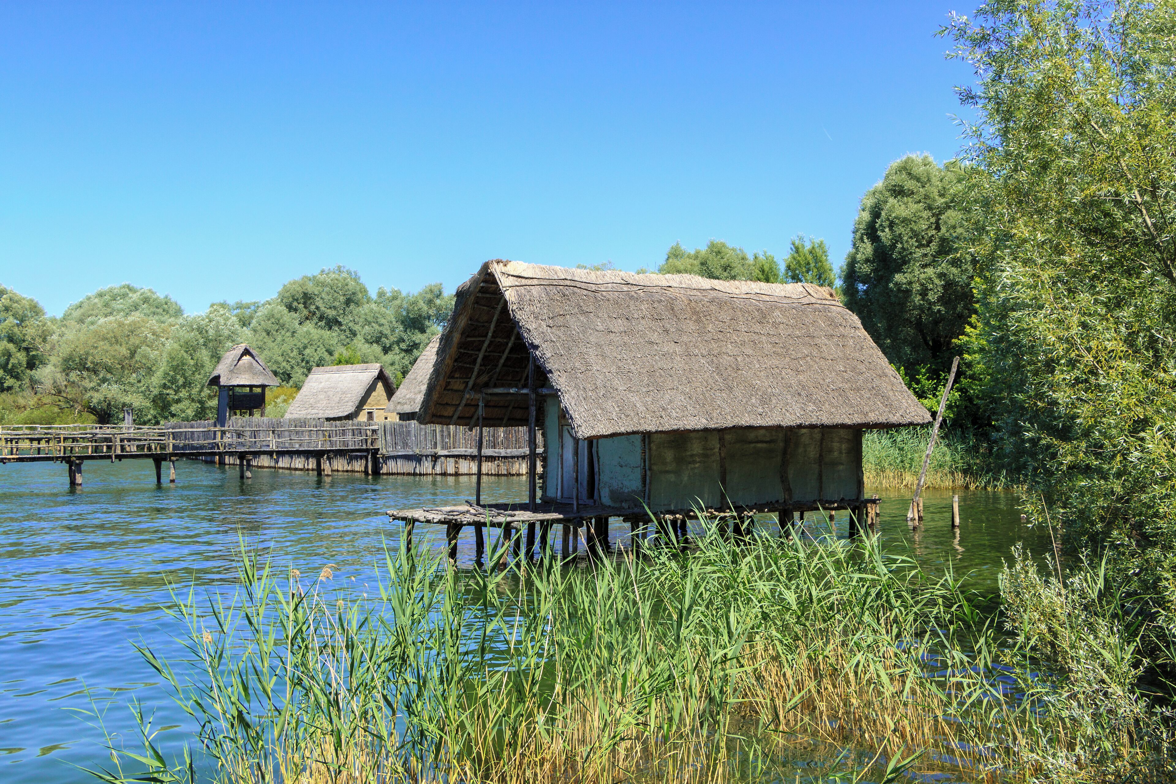 Hornstaad House and in the background the Stone Age Village Sipplingen, Pfahlbaumuseum Unteruhldingen, Uhldingen-Mühlhofen, Lake Constance, Germany