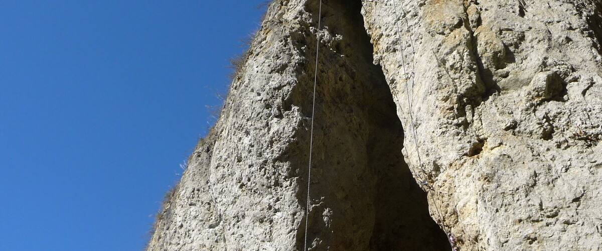 A rocky cliff with a climbing route.