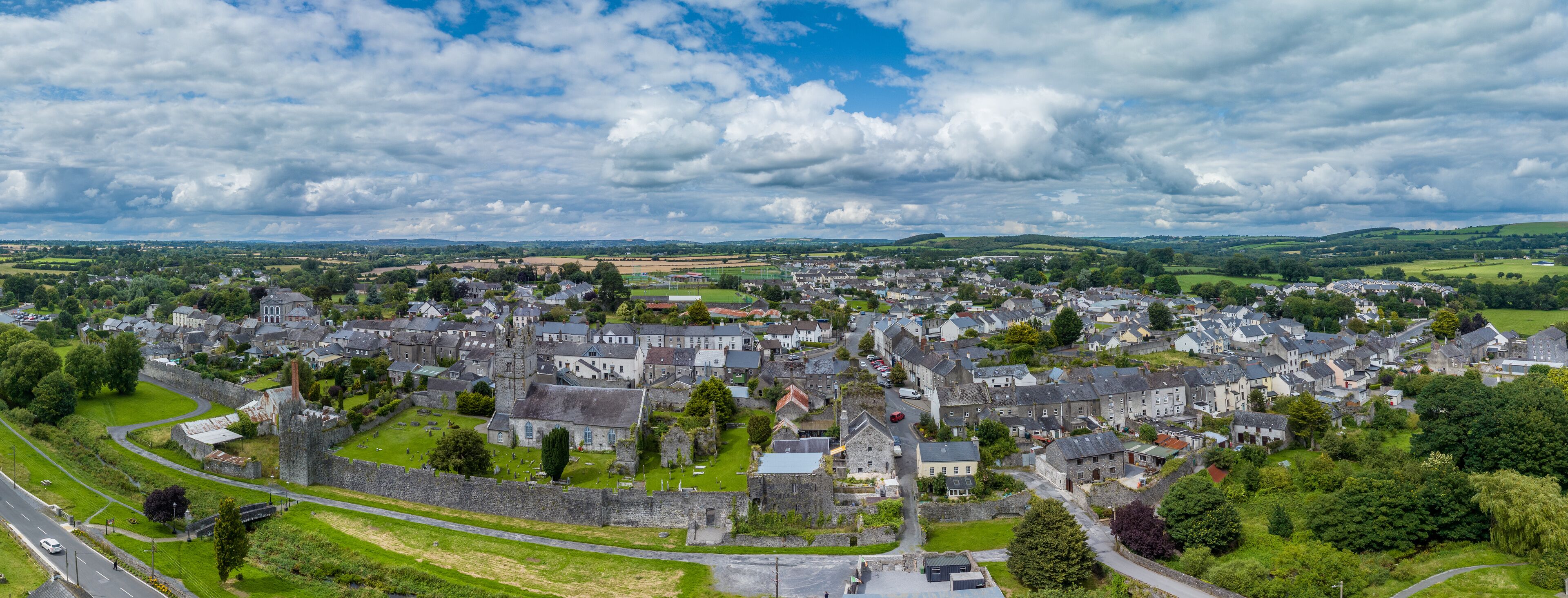 Aerial view of Fethard old medieval walled town in County Tipperary on the Clashawley River with Gothic Church and mural tower house