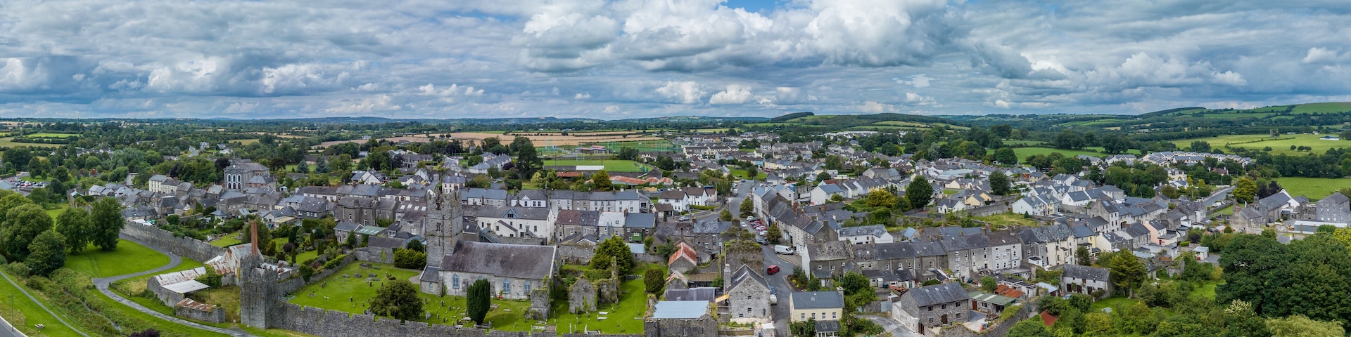 Aerial view of Fethard old medieval walled town in County Tipperary on the Clashawley River with Gothic Church and mural tower house