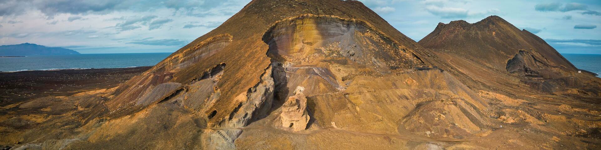 vibrant stairway; yellow walls; Ribeira Grande; street architecture; bright blue sky; urban charm; stairs; ascent; colorful; Cape Verde; cityscape; travel destination; picturesque; sunny; cultural arc
