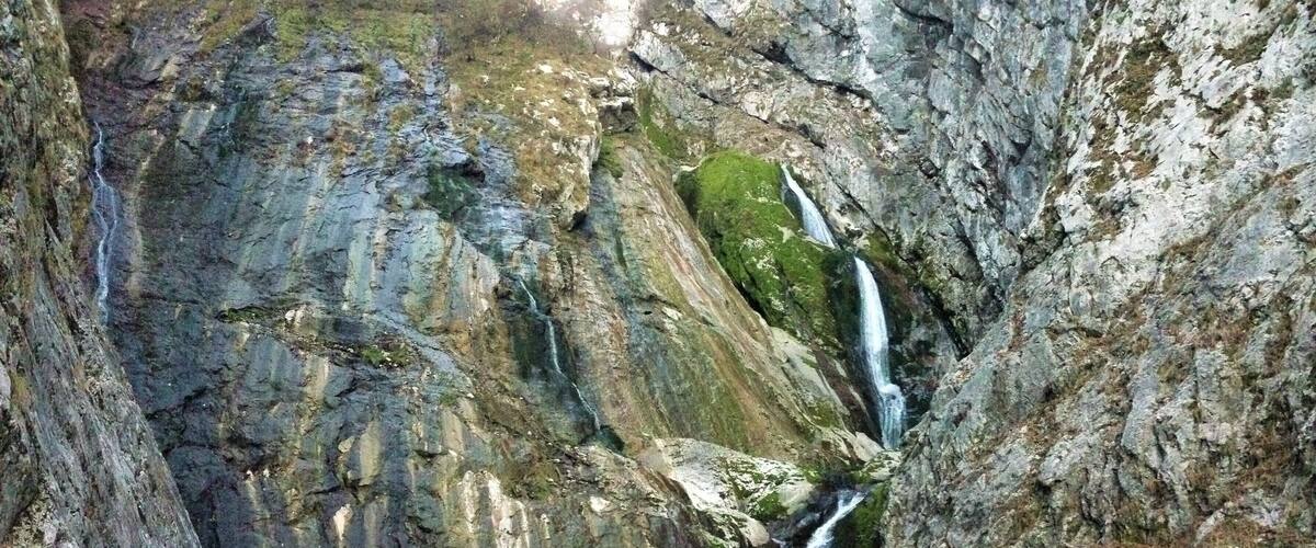A waterfall cascading down a rocky cliff into a pool.