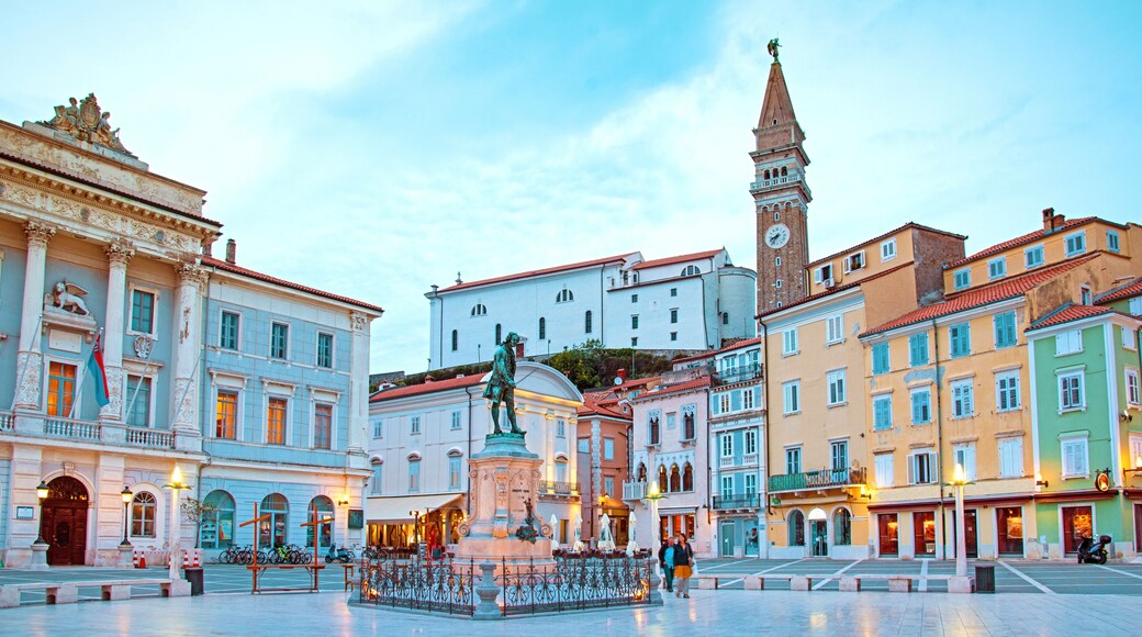 Beautiful street landscape on the central square with a monument and an ancient watch tower in Porec, Croatia's tourist center.