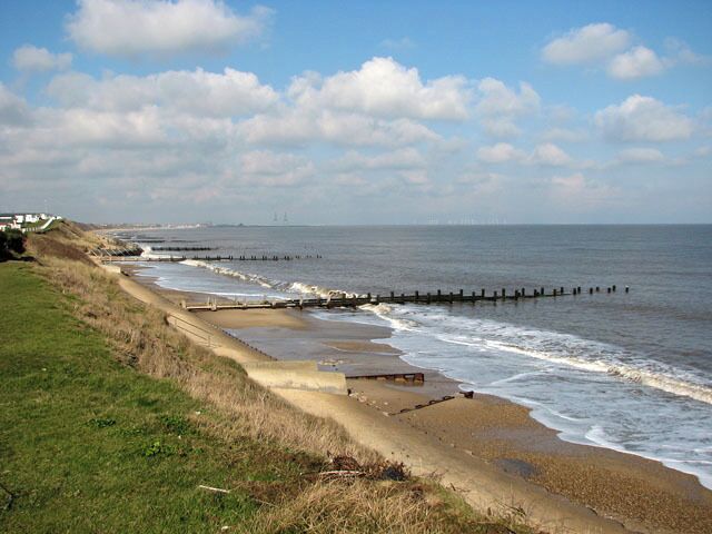 Seawall and groynes below Hopton-on-Sea. The Norfolk coastline is almost 100 miles long and extends from Hopton, just south of Great Yarmouth, northwards past the seaside resorts of Winterton, Happisburgh, Mundesley, Cromer, Sheringham and Holkham before it merges into Lincolnshire at King's Lynn. After the devastating floods in 1953, where 300 people lost their lives, the first sea defences were built along the coastline and at first the rate of erosion decreased. However, large portions of the revetments have been destroyed during the last 40 years, despite repairs, and beach and cliff erosion continue. The Shoreline Management Plan in its present format proposes no active intervention for a number of villages along the East Anglian coast, leaving them unprotected. One of these villages is Hopton, situated several miles south of Great Yarmouth, where the southern end of the Hopton to Corton seawall had to be closed due to storm damage, with the anticipation of a collapse of the structure > 1717919. A warning for walkers to take extra care has also been placed at the clifftop path > 1717876 where cliff falls on the path to Corton have occurred recently and more are expected > 1717883. Some blame the existence of the new outer harbour in Great Yarmouth for the loss of sand and beach area, and although some of the sand has since returned it is still at a low level. The privately owned East Port at Great Yarmouth, a multi-purpose facility integrating a new deep-water outer harbour, was opened in May 2007.