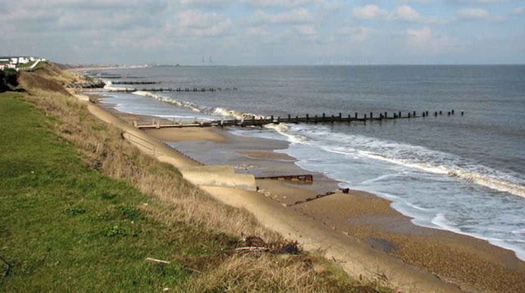 Seawall and groynes below Hopton-on-Sea. The Norfolk coastline is almost 100 miles long and extends from Hopton, just south of Great Yarmouth, northwards past the seaside resorts of Winterton, Happisburgh, Mundesley, Cromer, Sheringham and Holkham before it merges into Lincolnshire at King's Lynn. After the devastating floods in 1953, where 300 people lost their lives, the first sea defences were built along the coastline and at first the rate of erosion decreased. However, large portions of the revetments have been destroyed during the last 40 years, despite repairs, and beach and cliff erosion continue. The Shoreline Management Plan in its present format proposes no active intervention for a number of villages along the East Anglian coast, leaving them unprotected. One of these villages is Hopton, situated several miles south of Great Yarmouth, where the southern end of the Hopton to Corton seawall had to be closed due to storm damage, with the anticipation of a collapse of the structure > 1717919. A warning for walkers to take extra care has also been placed at the clifftop path > 1717876 where cliff falls on the path to Corton have occurred recently and more are expected > 1717883. Some blame the existence of the new outer harbour in Great Yarmouth for the loss of sand and beach area, and although some of the sand has since returned it is still at a low level. The privately owned East Port at Great Yarmouth, a multi-purpose facility integrating a new deep-water outer harbour, was opened in May 2007.