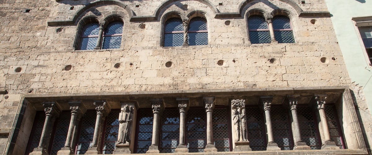 A historic building with arched windows and columns.
