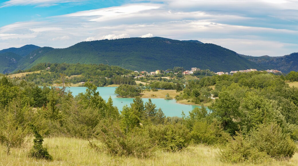 Summer scenery of the lake and the village of castel san vincenzo, immersed in the green of nature, Molise, Italy