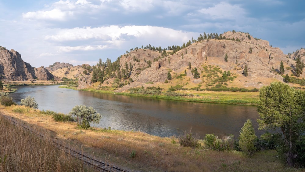 Panorama of railroad tracks running along the Missouri River near Craig, Montana, USA