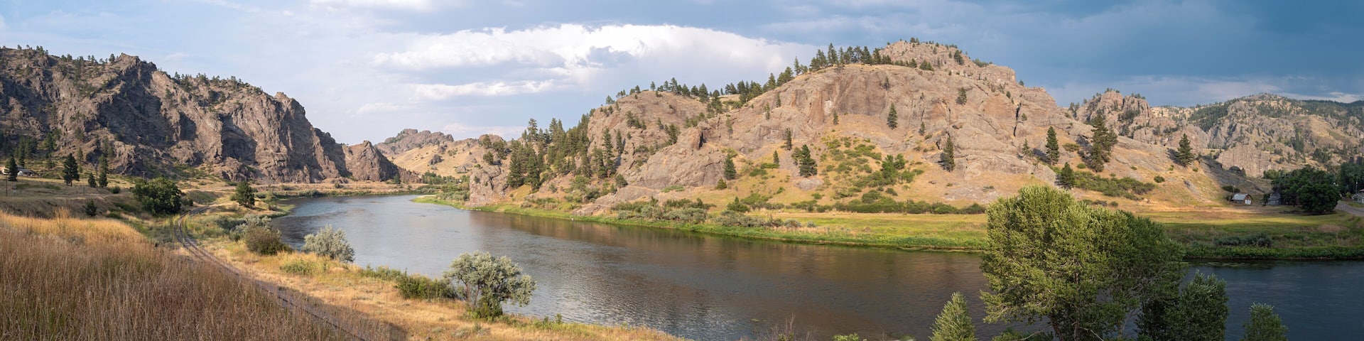 Panorama of railroad tracks running along the Missouri River near Craig, Montana, USA