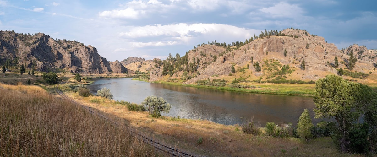 Panorama of railroad tracks running along the Missouri River near Craig, Montana, USA