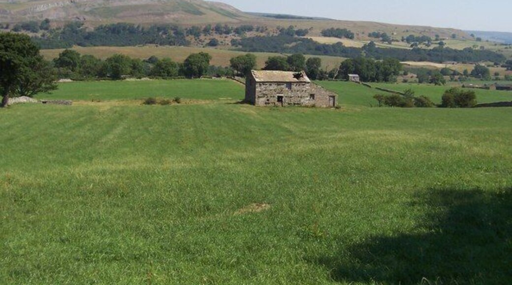 Stone Barn in Wensleydale. Somewhat ravaged structure to the east of Thornton Rust. The view looks across Wensleydale to the prominent outcrops on Ivy Scar.