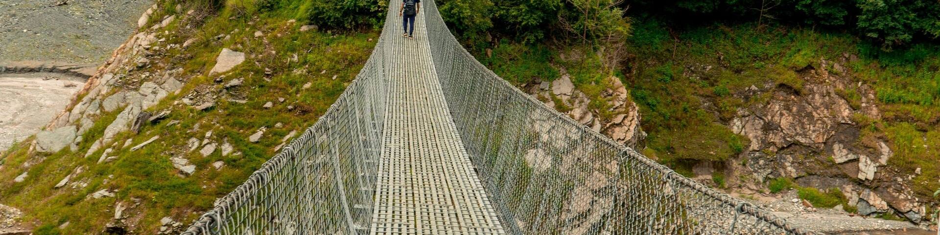 Vertical shot of a suspension bridge and dense forest on the background in Markhu, Makwanpur, Nepal