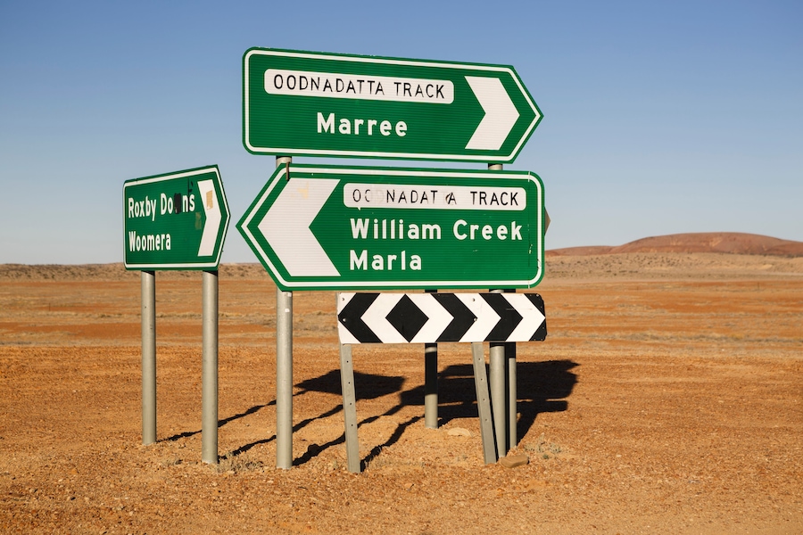 Roxby Downs Woomera, Maree and William Creek Marla Oodnadatta Track signposts roadside in the Australian Outback, South Australia
