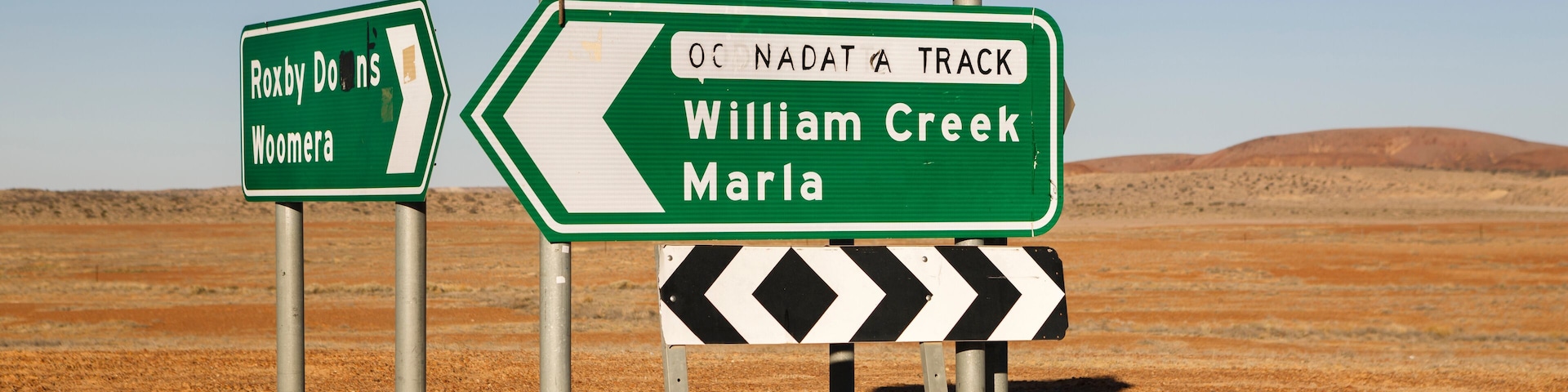 Roxby Downs Woomera, Maree and William Creek Marla Oodnadatta Track signposts roadside in the Australian Outback, South Australia