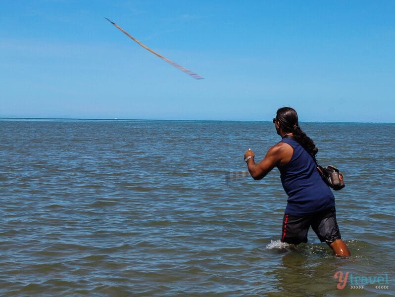 A person flying a kite in the water.