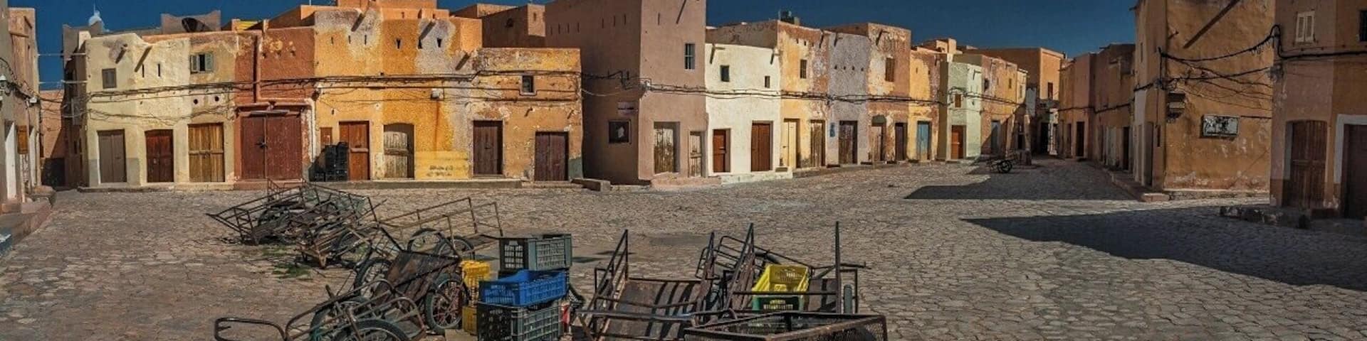 April 2011
Marché a la Criée, Beni Isguen, M'zab valley, Algeria
Marché a la Criée is a market place in Beni Isguen town. It is the largest of the five Ibadi villages of M'zab valley in Algeria, some 600 km south of Algiers.
Late in the afternoon it becomes the centre of the social life of Beni Isguen with the daily auction. Those who sell yell out the price of their item until someone buys it or the price is brought down.
This picture was taken during Friday prayer time, when it feels like a western movie town at noon (maybe apart from the carriages :)
#unesco
M'zab valley including the village of Beni Isguen is since 1982 a well deserved UNESCO World heritage site.
A quote from the UNESCO reasoning:
A traditional human habitat, created in the 10th century by the Ibadites around their five ksour (fortified cities), has been preserved intact in the M’Zab valley. Simple, functional and perfectly adapted to the environment, the architecture of M’Zab was designed for community living, while respecting the structure of the family. It is a source of inspiration for today’s urban planners.