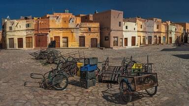 April 2011
Marché a la Criée, Beni Isguen, M'zab valley, Algeria
Marché a la Criée is a market place in Beni Isguen town. It is the largest of the five Ibadi villages of M'zab valley in Algeria, some 600 km south of Algiers.
Late in the afternoon it becomes the centre of the social life of Beni Isguen with the daily auction. Those who sell yell out the price of their item until someone buys it or the price is brought down.
This picture was taken during Friday prayer time, when it feels like a western movie town at noon (maybe apart from the carriages :)
#unesco
M'zab valley including the village of Beni Isguen is since 1982 a well deserved UNESCO World heritage site.
A quote from the UNESCO reasoning:
A traditional human habitat, created in the 10th century by the Ibadites around their five ksour (fortified cities), has been preserved intact in the M’Zab valley. Simple, functional and perfectly adapted to the environment, the architecture of M’Zab was designed for community living, while respecting the structure of the family. It is a source of inspiration for today’s urban planners.