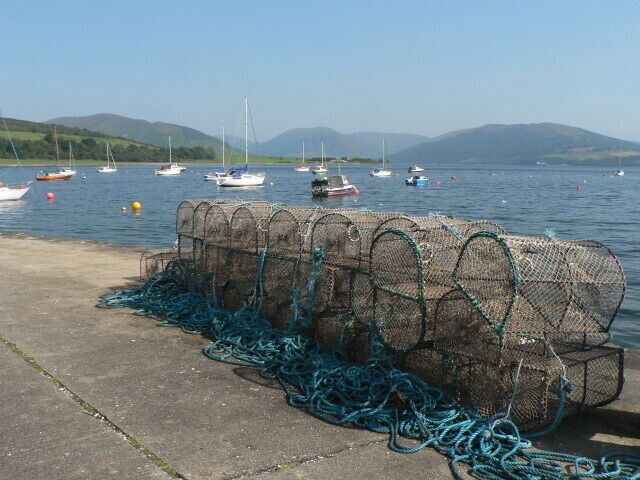 Port Bannatyne: lobsterpots on the pier A view out to sea from 922663, the mainland Argyll hills in the distance.