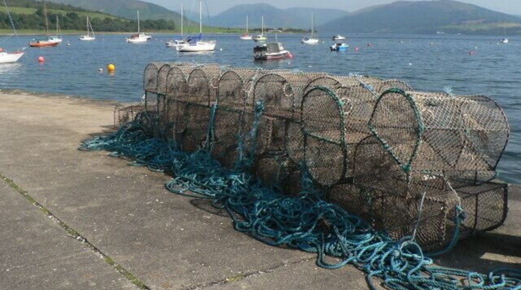 Port Bannatyne: lobsterpots on the pier A view out to sea from 922663, the mainland Argyll hills in the distance.