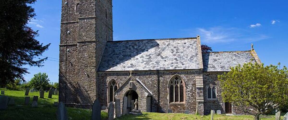 A historic church with a tall tower and arched windows.