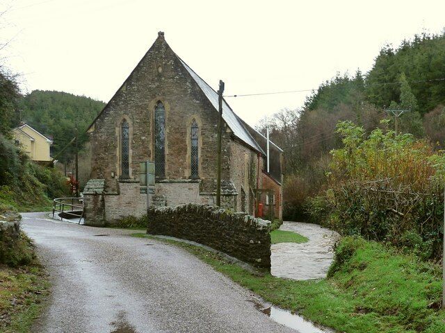 An engorged Bradiford water running past the United Reformed Church in Muddiford