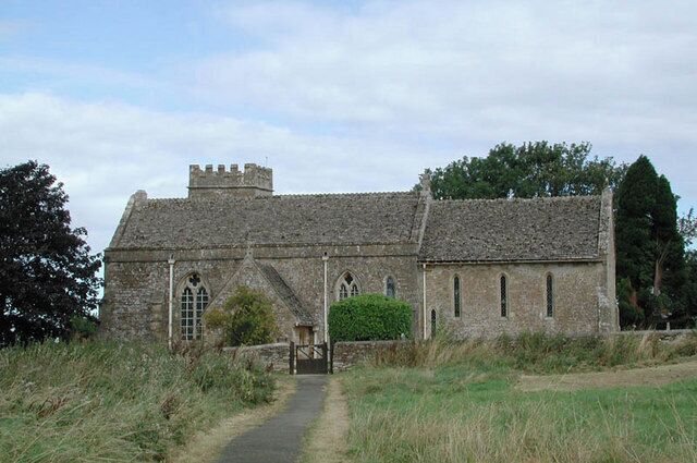 A stone church with a pathway leading to its entrance.