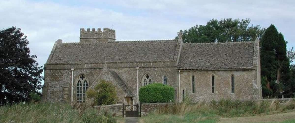 A stone church with a pathway leading to its entrance.