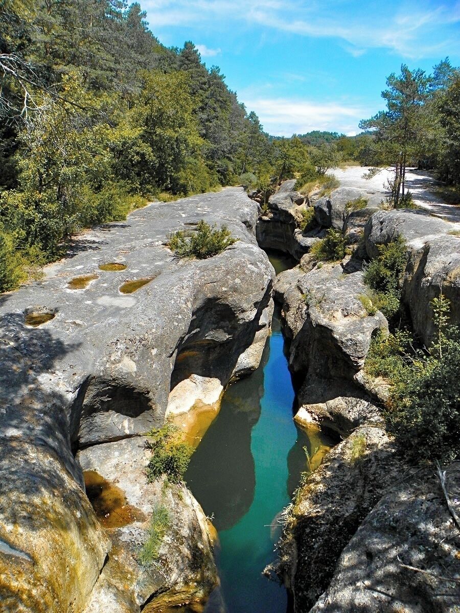 A rocky landscape with a narrow stream.