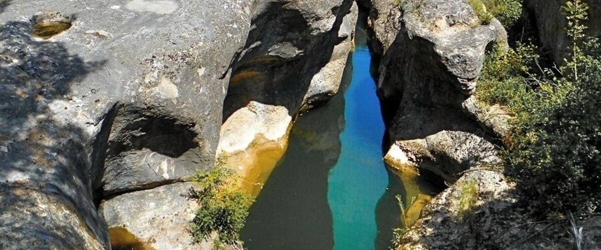 A rocky landscape with a narrow stream.