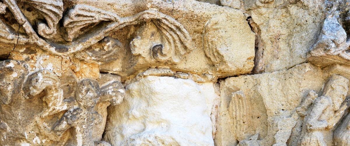 A detailed stone carving with intricate designs and figures.