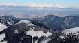 The Low Tatras in the foreground, High Tatras in the background and a wide valley in the middle. I definitely was high up to get this view :). I was on Mt. Chopok, which is at 2,024 m (6,640 ft) and is the 3rd highest peak of the Low Tatra Range. It's also inside the Low Tatras National Park. The views were truly breathtaking from there! This is absolutely one of my favorite views. And with the heat outside it's good to remember winter ;).