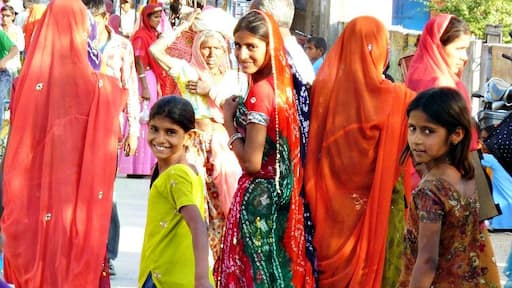 Women and girls in colourful saris on a festival day in the small town of Jojawar in Rajasthan.