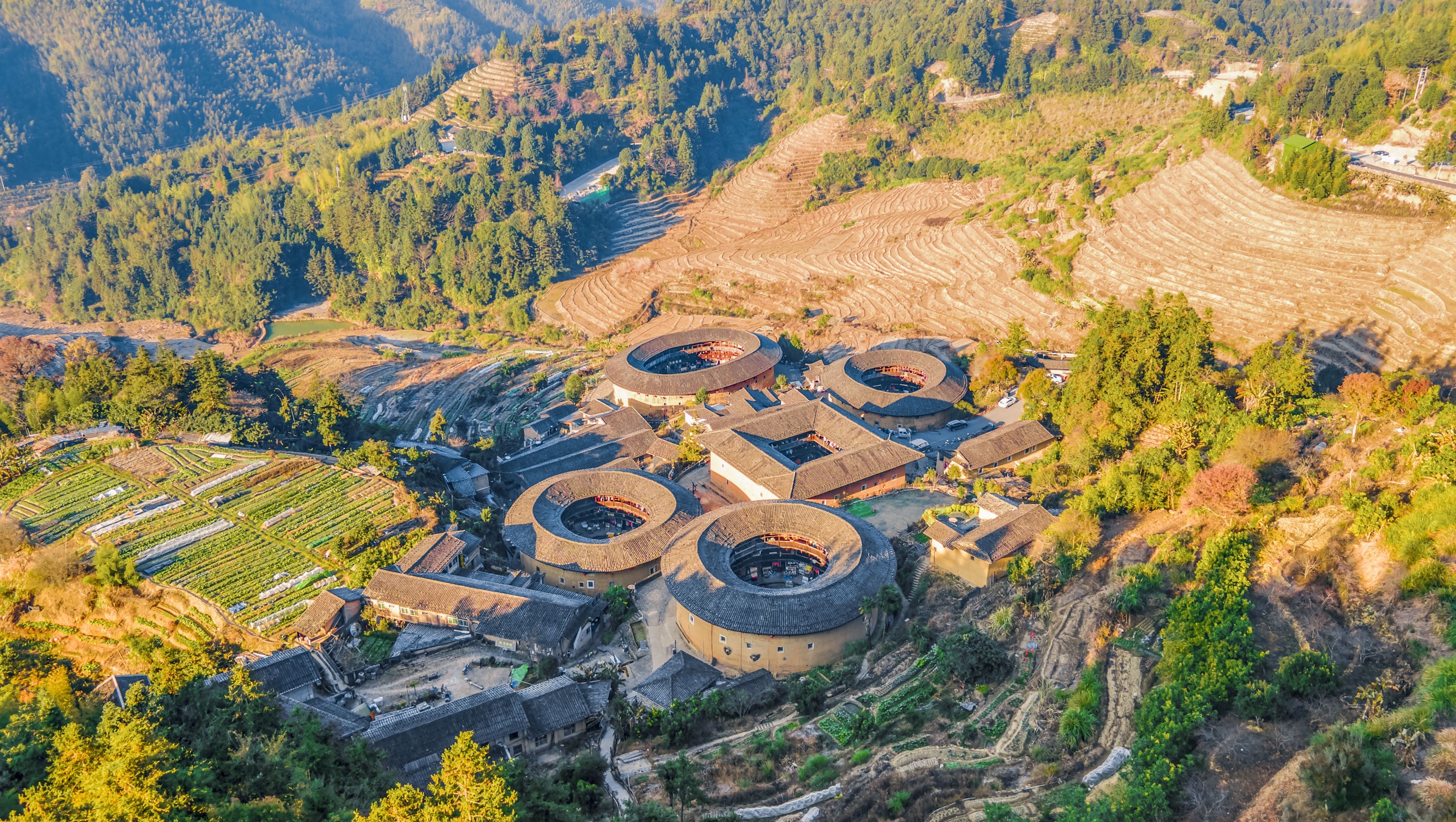 A terraced agricultural landscape with circular buildings.
