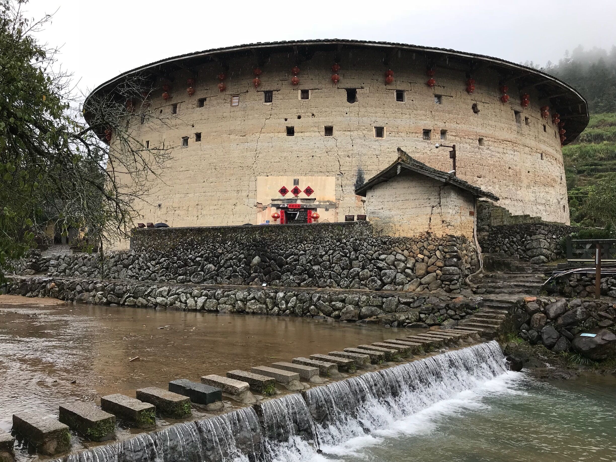 A huge Round House set against picturesque mountains. 