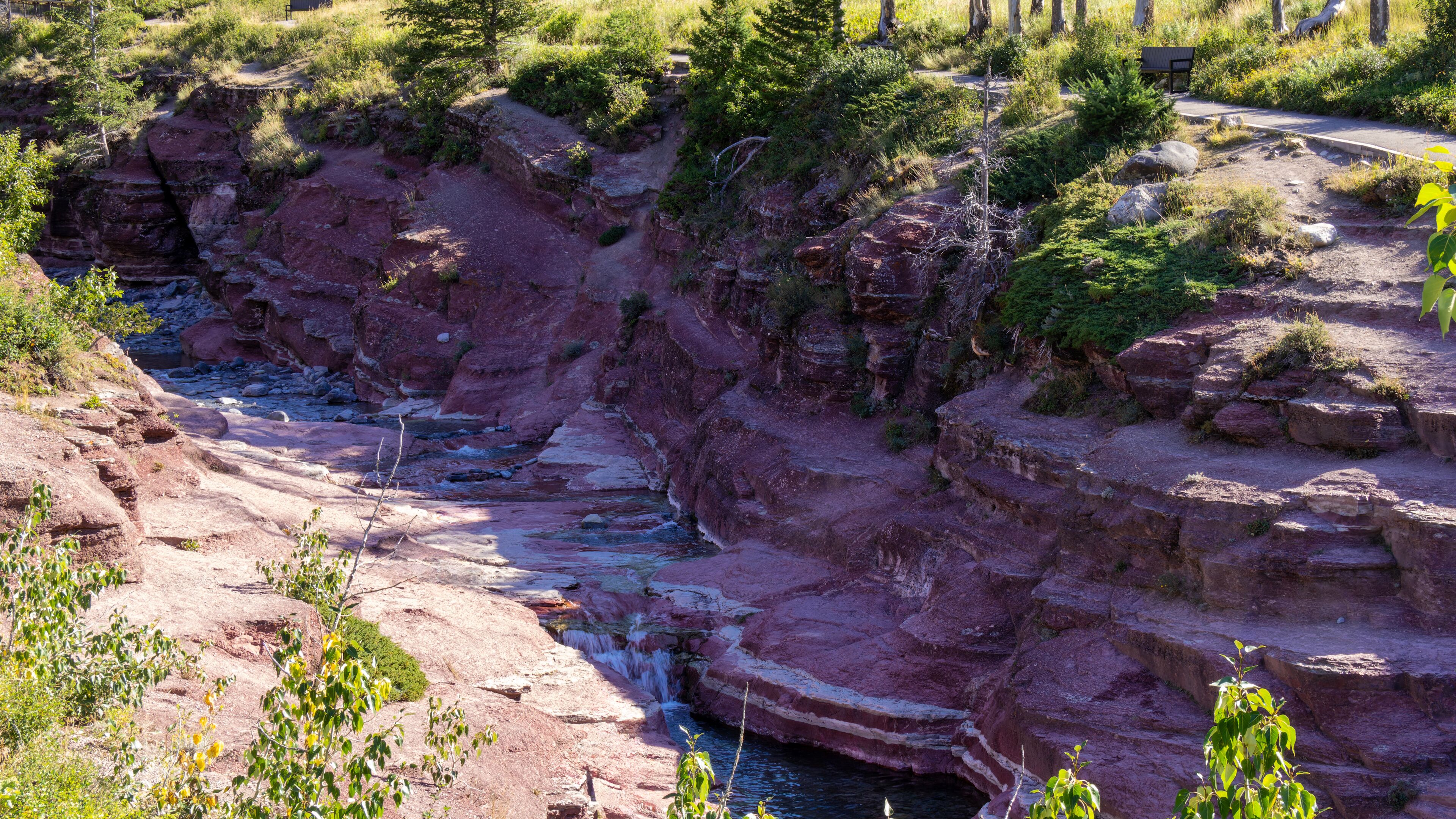 A canyon with a river flowing through it, surrounded by rocky cliffs and sparse vegetation.