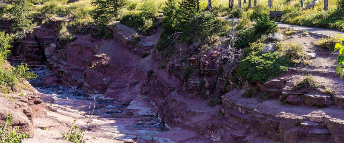 A canyon with a river flowing through it, surrounded by rocky cliffs and sparse vegetation.
