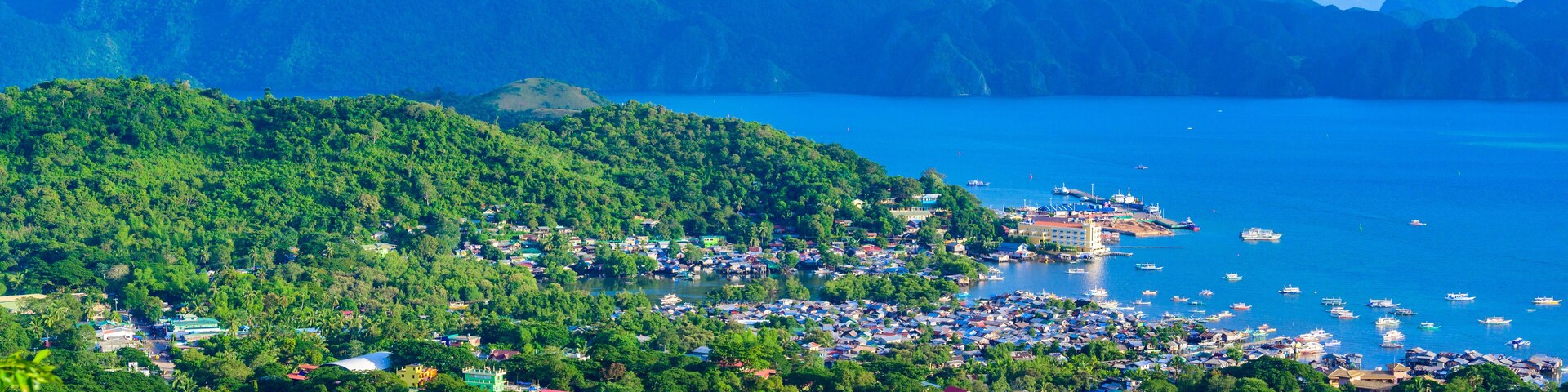 View of Coron Town and Bay from Mount Tapyas on Busuanga Island at sunset - tropical destination with paradise landscape scenery, Palawan, Philippines.